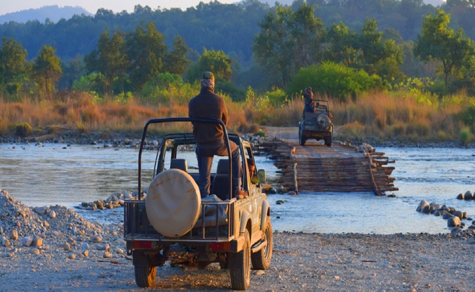 Off-road adventure: man driving a jeep through the river.